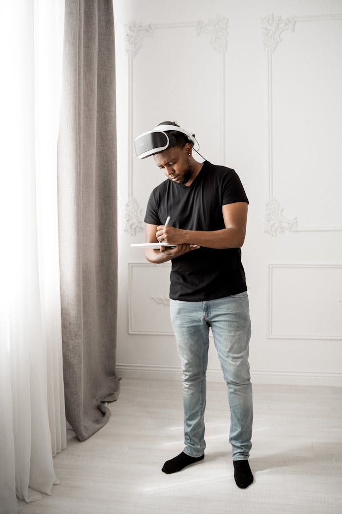 Mastering the First Impression: Your intriguing post title goes here A man wearing VR glasses explores virtual reality indoors using a tablet.